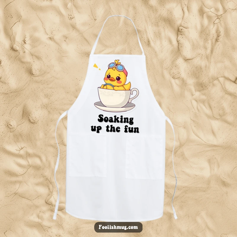 Funny apron with a confused rubber ducky character piloting a teacup, adding a whimsical touch to kitchen duties.