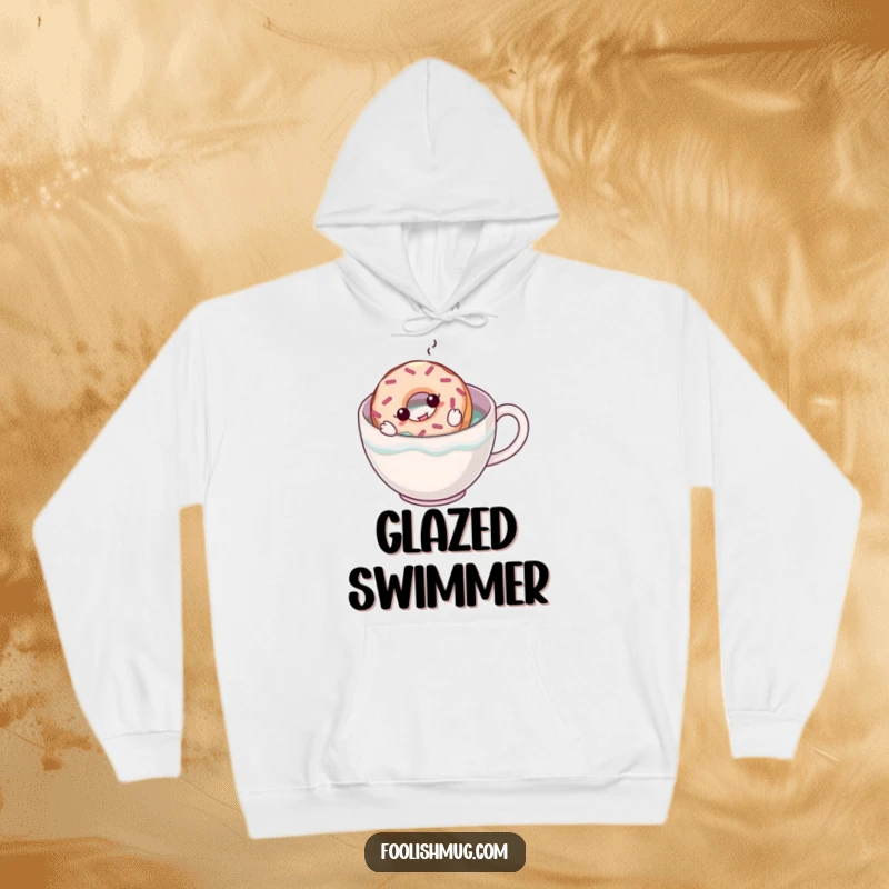 Funny hoodie featuring a cartoon donut trying to swim in a large coffee mug, offering humorous comfort for coffee and donut enthusiasts.