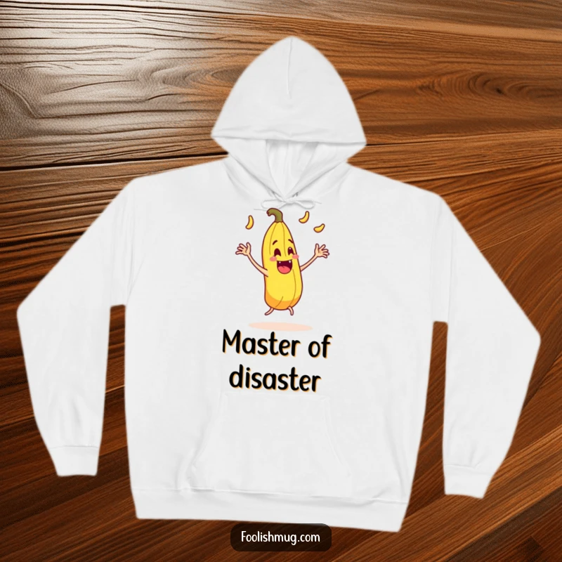 Funny juggling banana peel character comically slipping on itself with exaggerated motion on a hoodie, a warm and humorous garment.