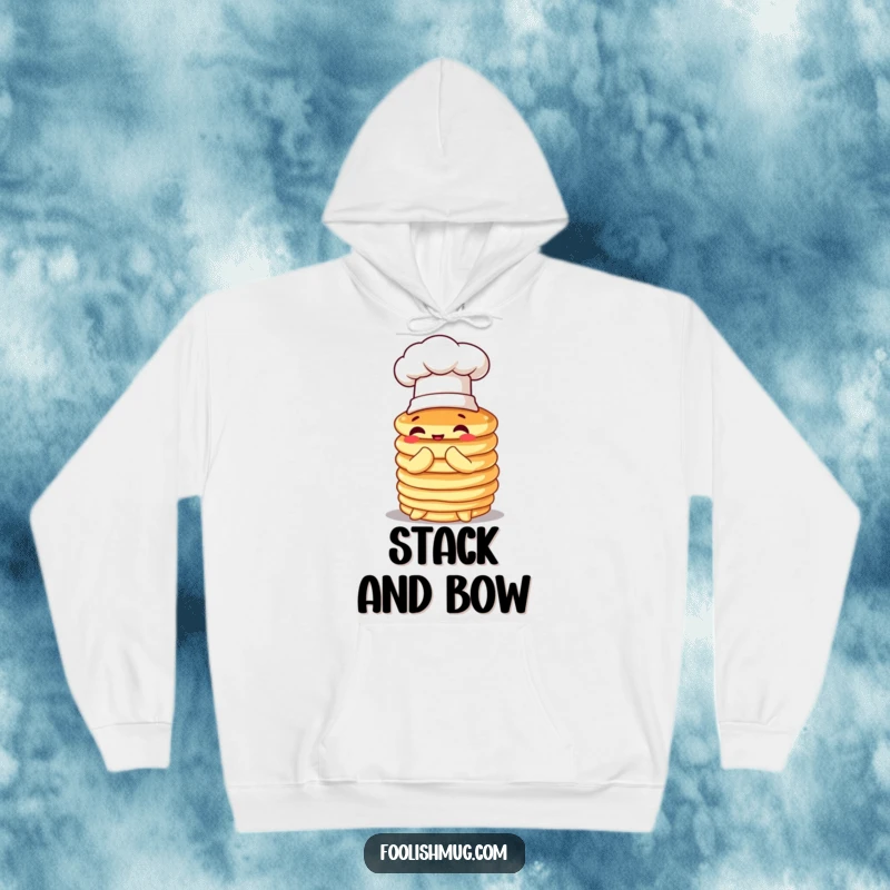 Funny pancake hoodie, wobbly stack wearing a tiny chef hat, comically attempting to bow, perfect for cozy, humorous breakfast moments.