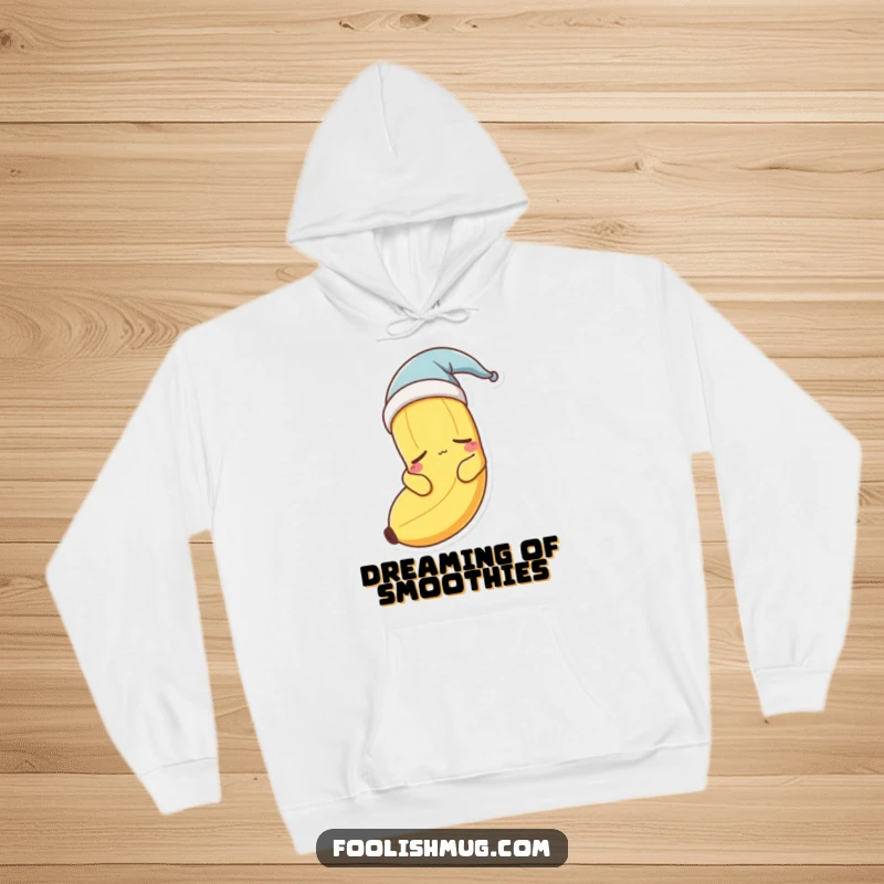 Funny sleepy banana character wearing a nightcap, looking drowsy on a warm hoodie.