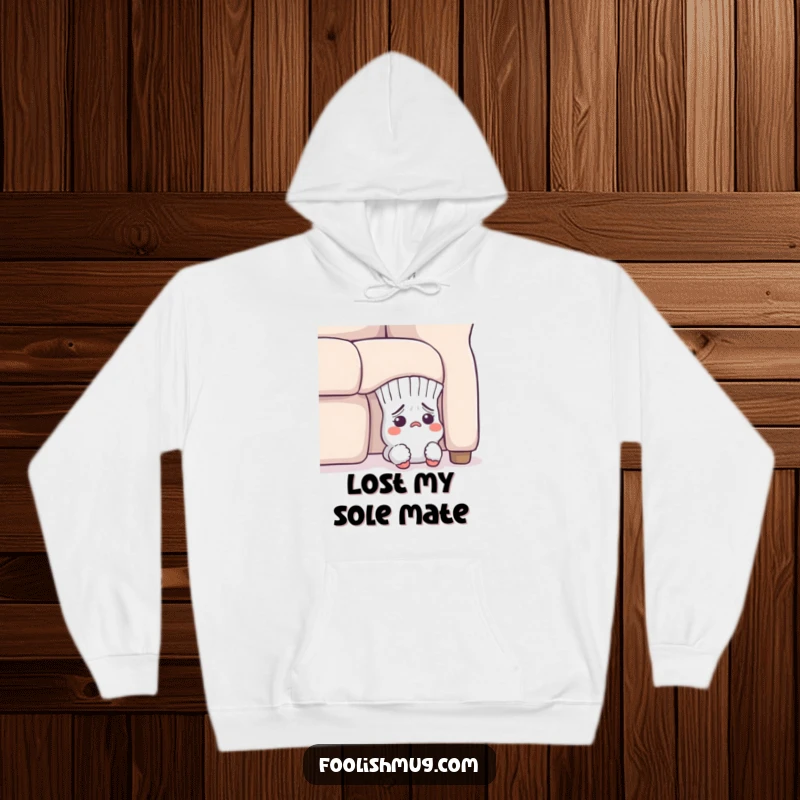 Funny Hoodie: A lost sock character looking flustered while peeking from under a sofa, offering warmth and humor.