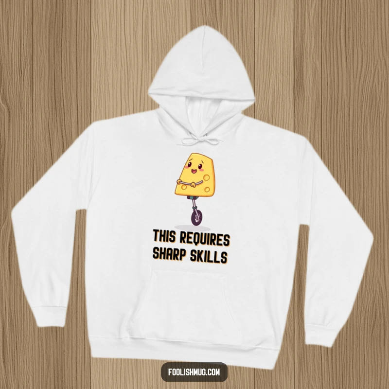 Funny hoodie featuring a slice of cheese on a unicycle, maintaining a wobbly balance, radiating cheerful determination and cheesy delight.