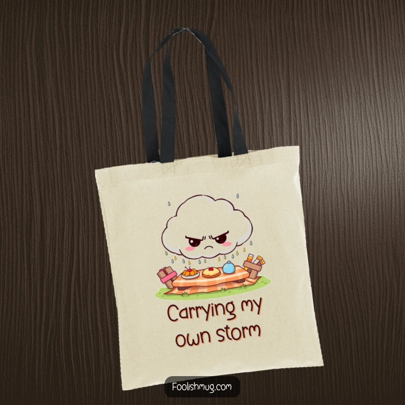 Funny grumpy cloud tote bag, raining tiny frowns on a sunny picnic, quirky and funny gift.